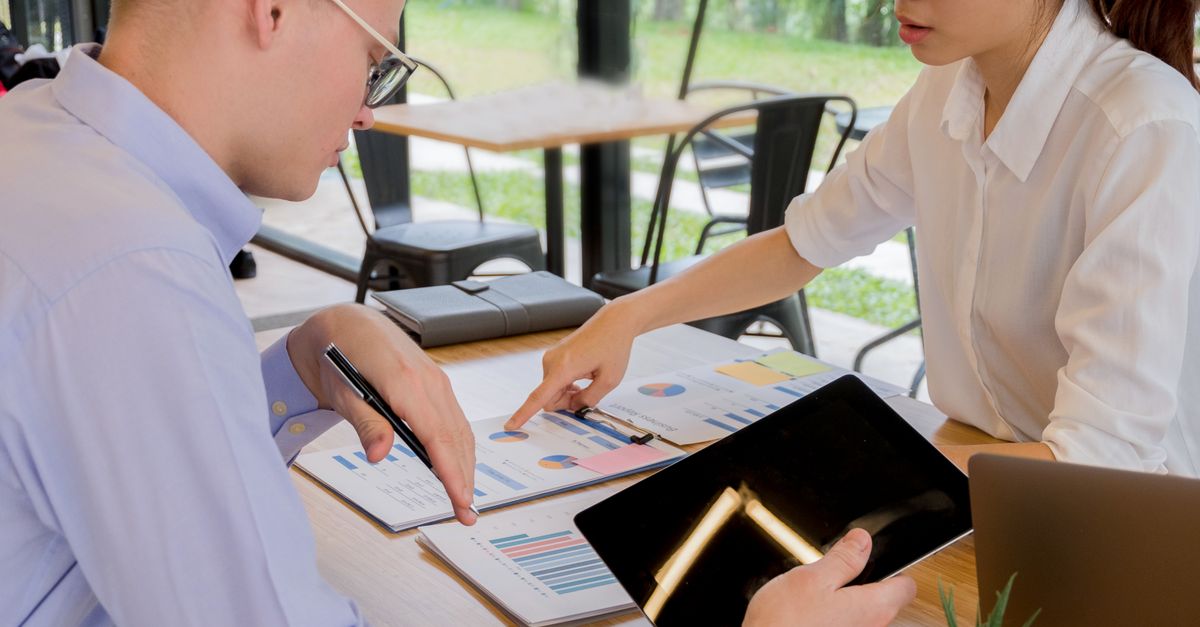 Team collaboration over financial documents in a modern office setting.
